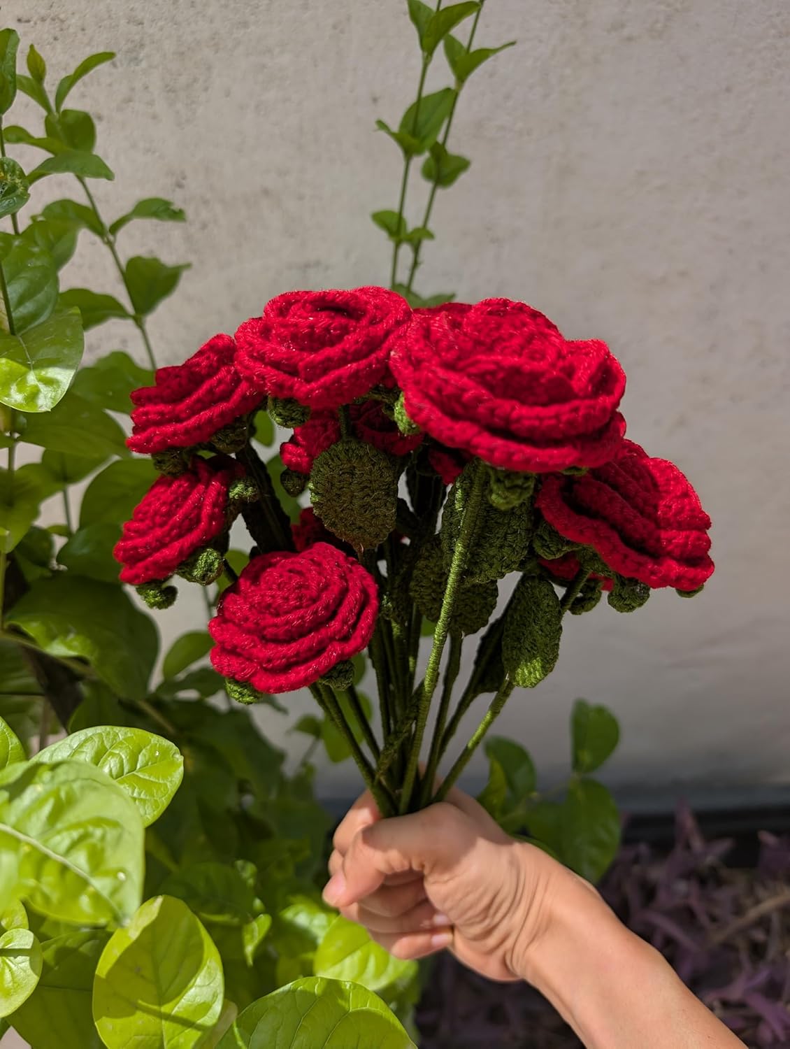 Handmade crochet red rose bouquet wrapped in black paper with a red ribbon, unique gift for special occasions.