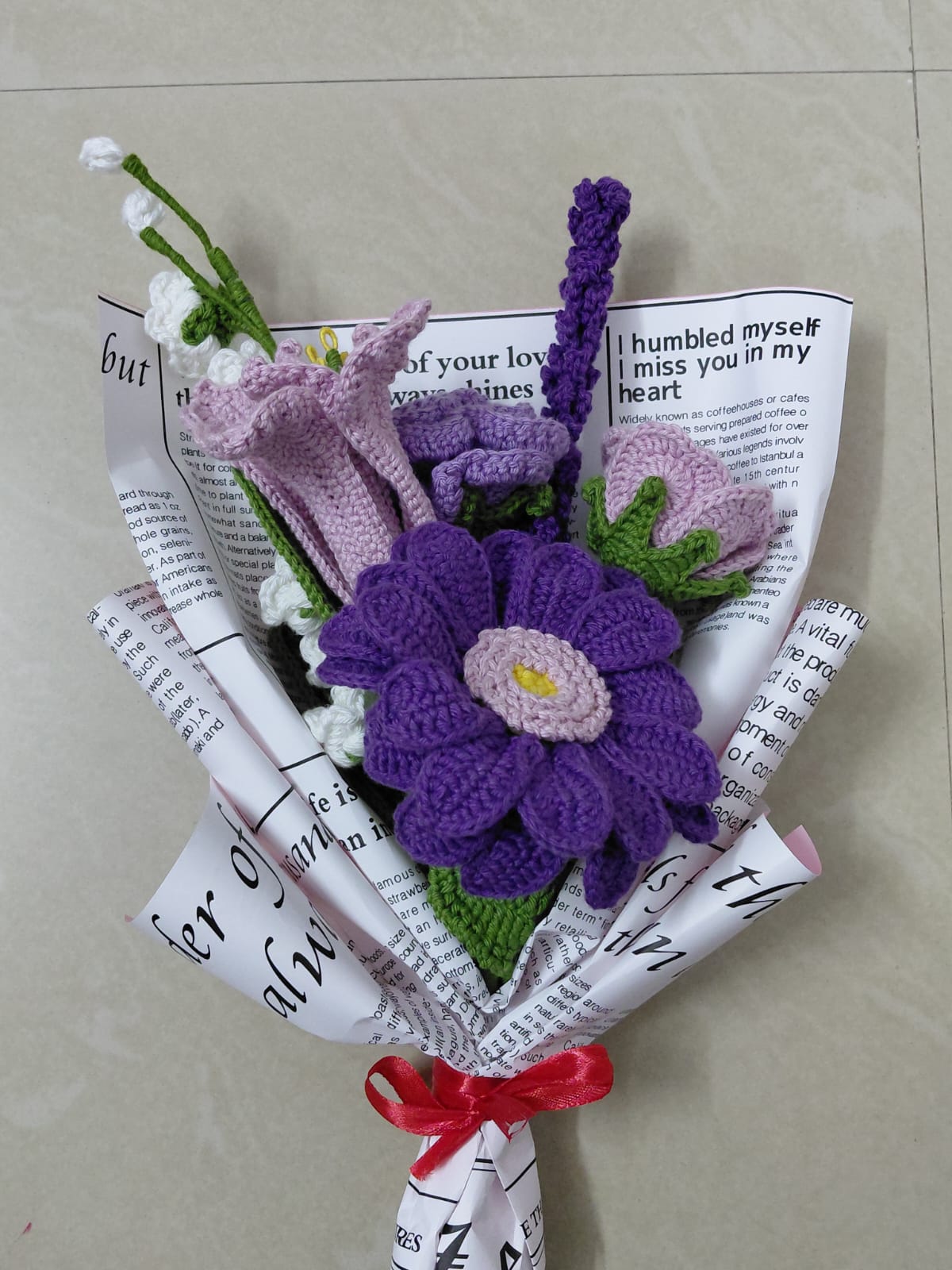 Eco-friendly handmade crochet bouquet with purple daisy, pink roses, and green leaves, long-lasting gift for anniversaries and décor.