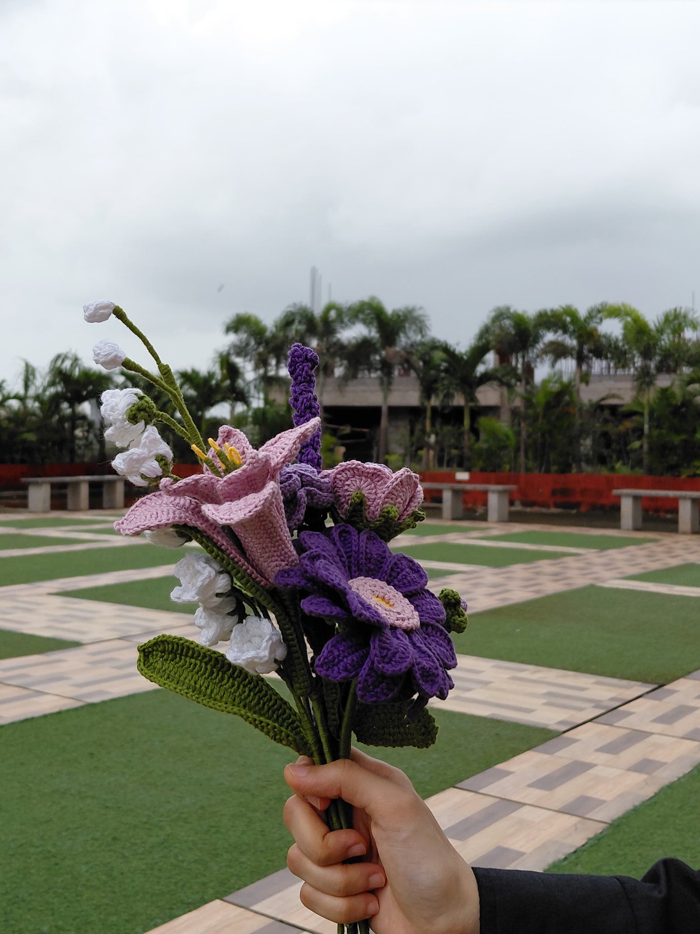 Handcrafted crochet flower bouquet with detailed purple, pink, and white flowers, ideal for sustainable gifting and decoration.