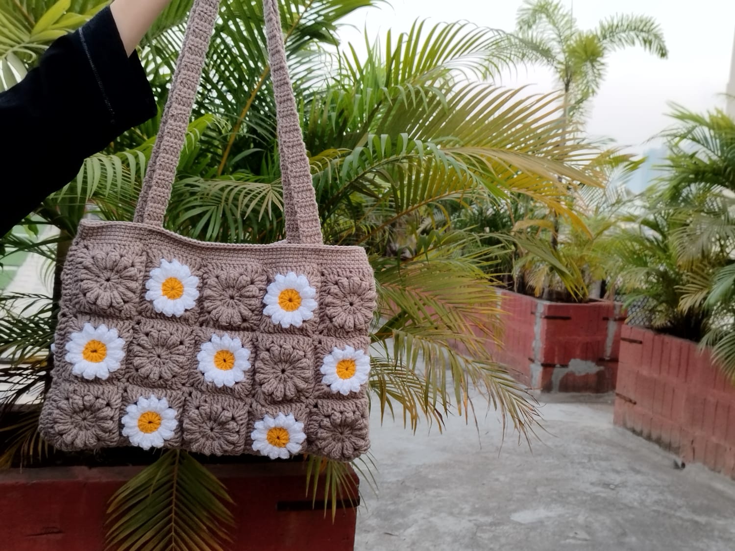 Crochet floral granny square handbag, trendy sustainable bag for women, matching Gen Z fashion and eco-conscious style.