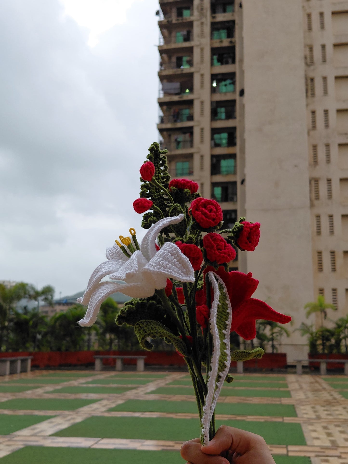 Beautiful handmade crochet floral bouquet featuring roses, lilies, and greenery, perfect for unique gifts and décor.