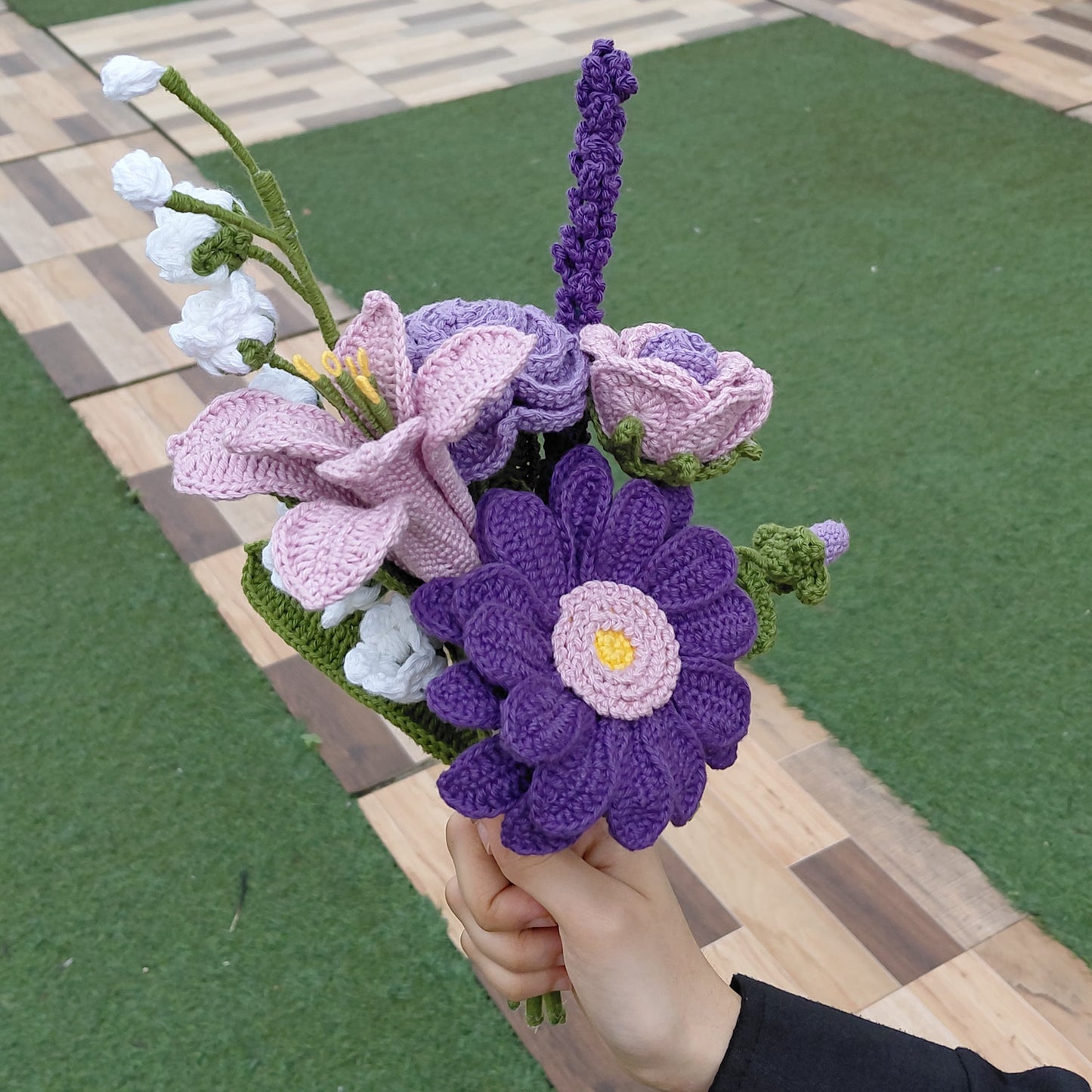 Crochet bouquet of purple and pink flowers, handcrafted with yarn, sustainable alternative to fresh flowers for weddings and gifting.