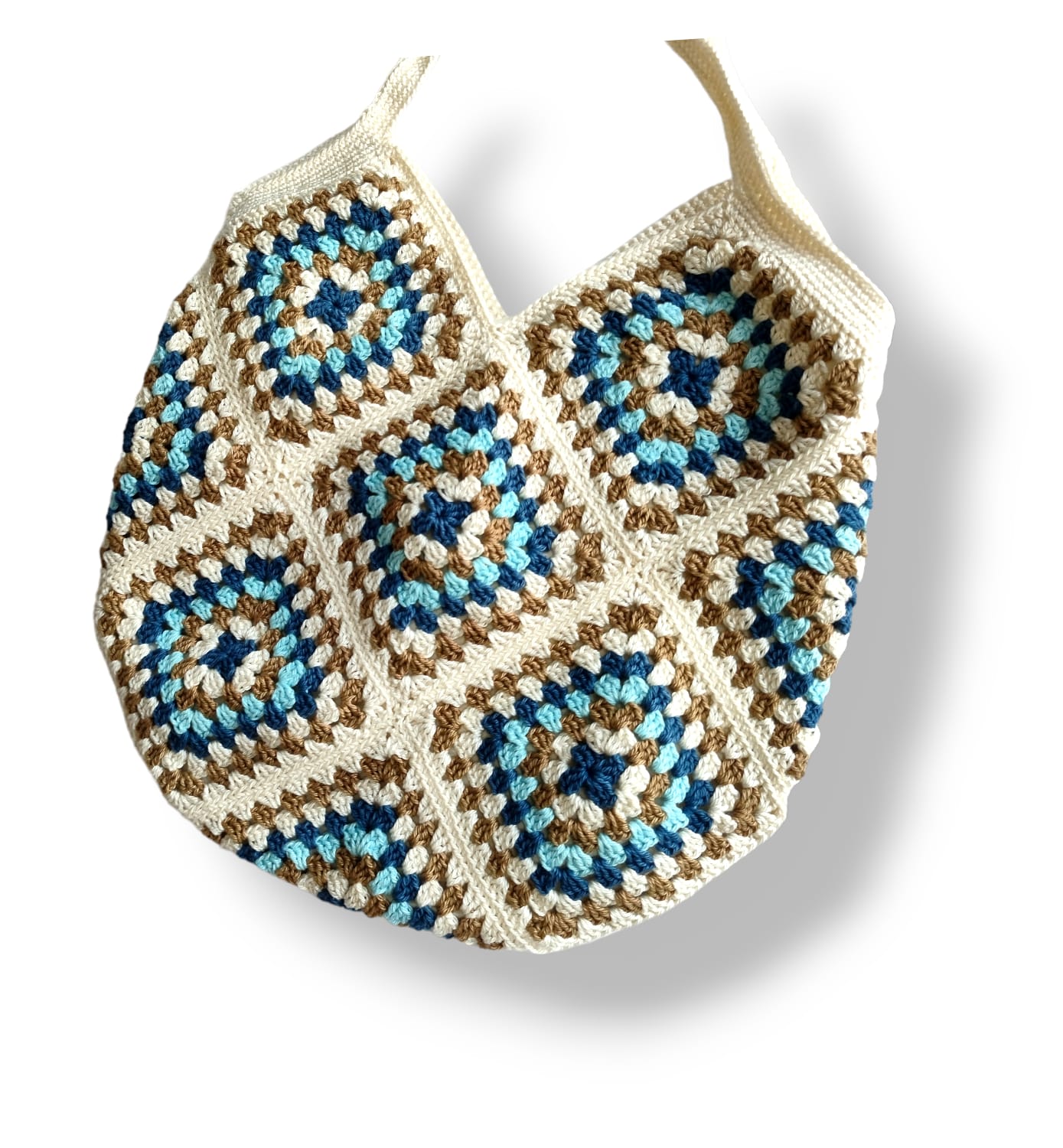 Crochet shoulder bag with blue, white, and brown granny square pattern, stylish handmade accessory.